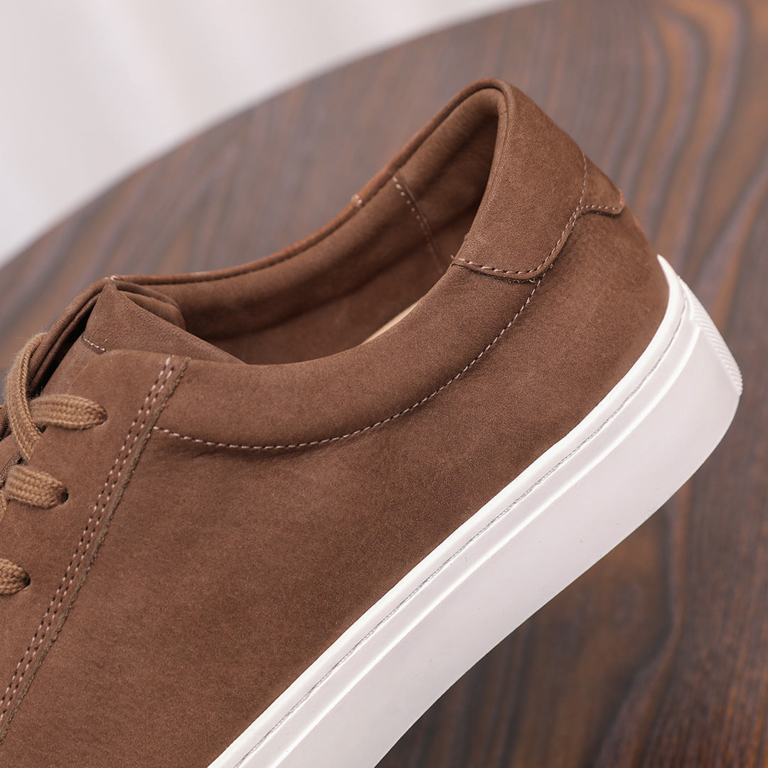 Brown suede leather sneaker, side view with lace-up and stitched quarter panels