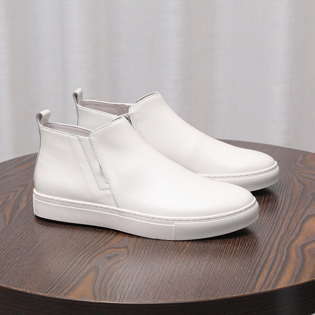 White leather pointed-toe dress boots with side zippers and white rubber soles