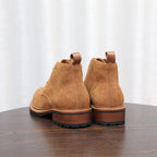 Men's tan suede chukka boots rear view, lace-up style with rubber heel sole