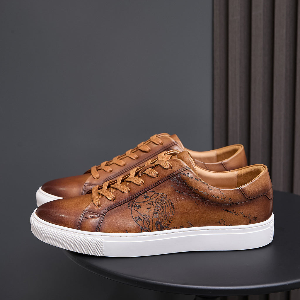 Men's tan leather sneakers with lace-up front, embossed details, and white rubber sole