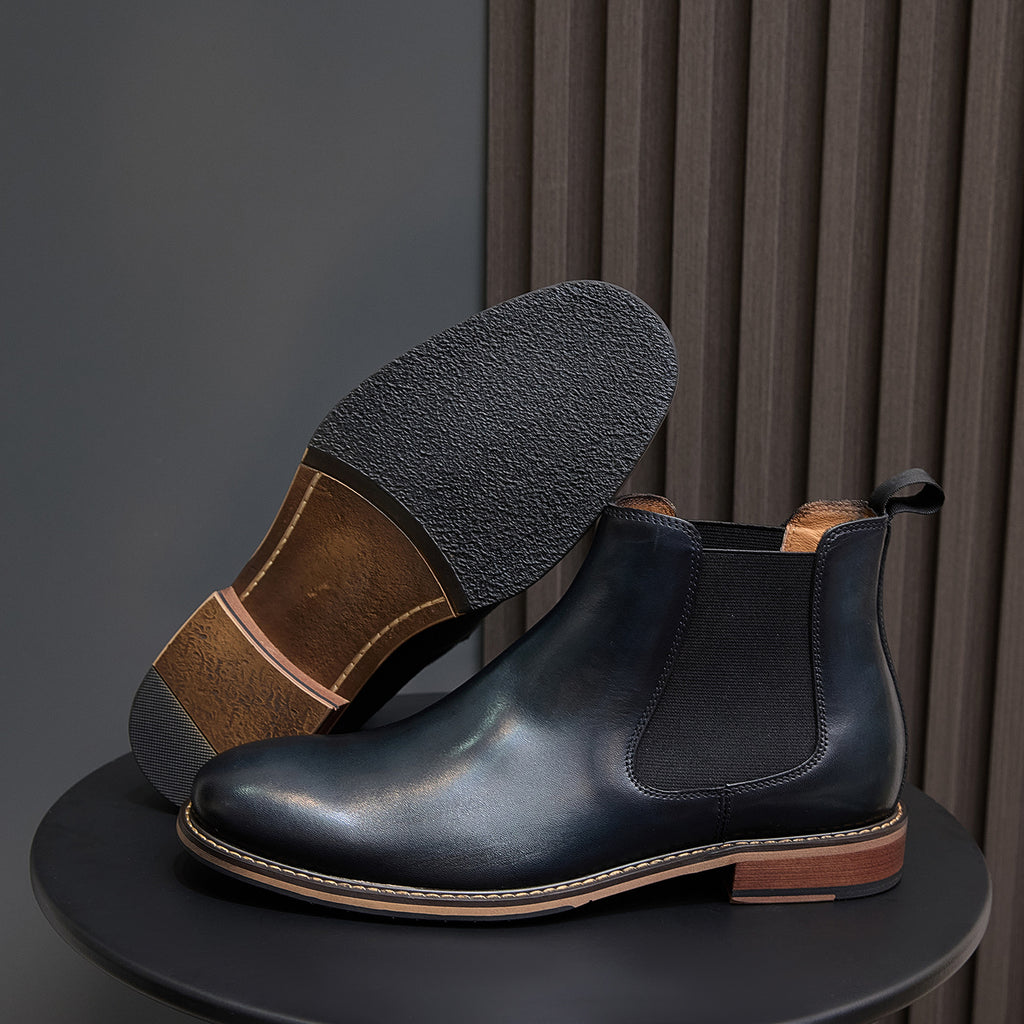 Pointed-toe Chelsea dress boots in dark blue with side elastic and tan welt stitching