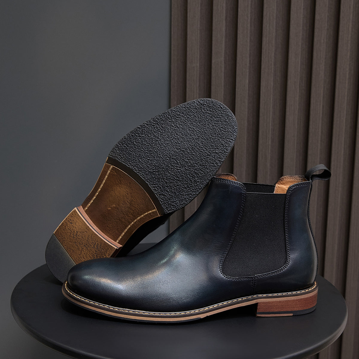 Pointed-toe Chelsea dress boots in dark blue with side elastic and tan welt stitching