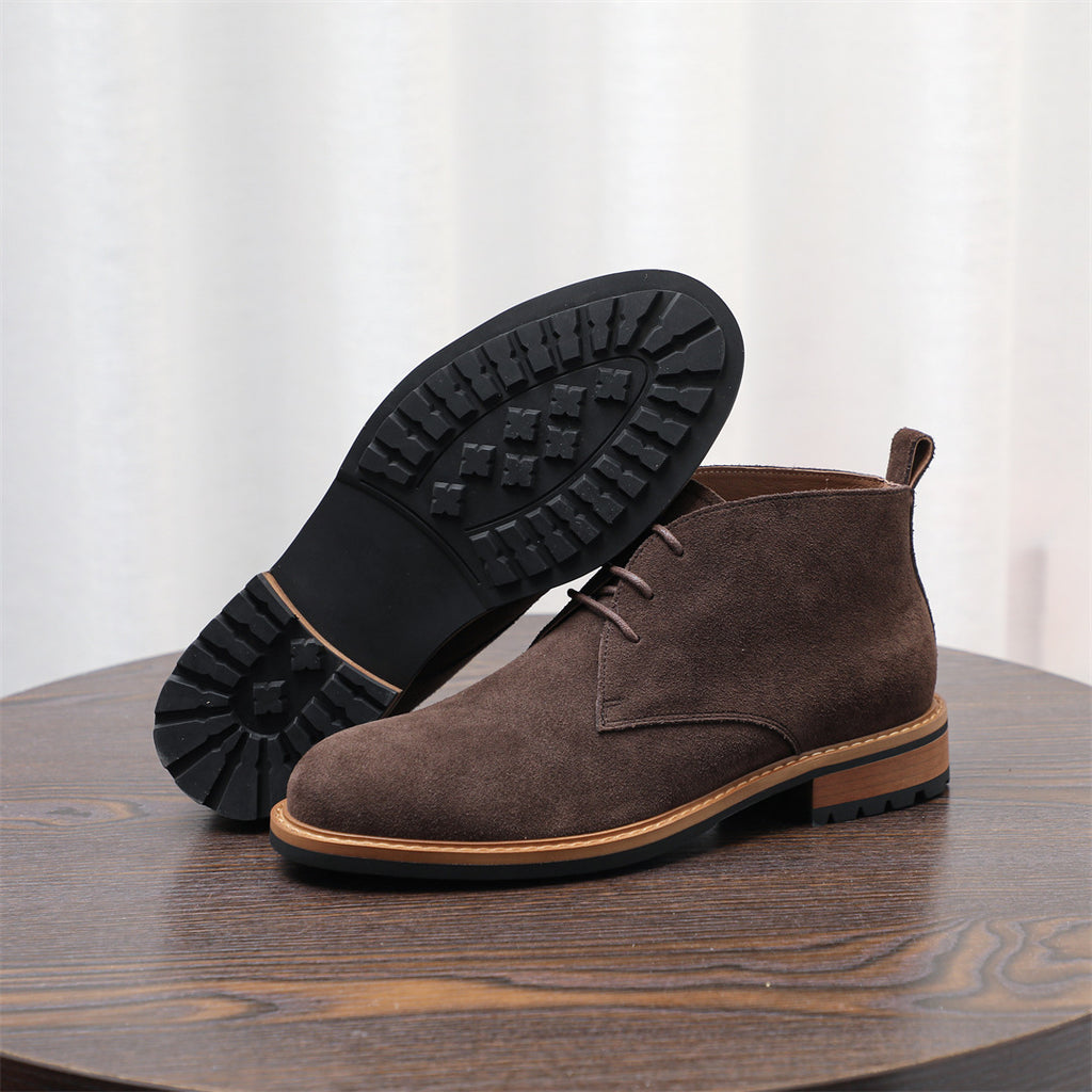 Dark brown suede chukka boot with lace-up, showing textured rubber tread outsole.