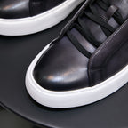 Close-up of black leather sneaker toe and lace-up with white platform sole