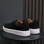 Men's genuine leather sneakers, black, rear view with padded heel and white midsole