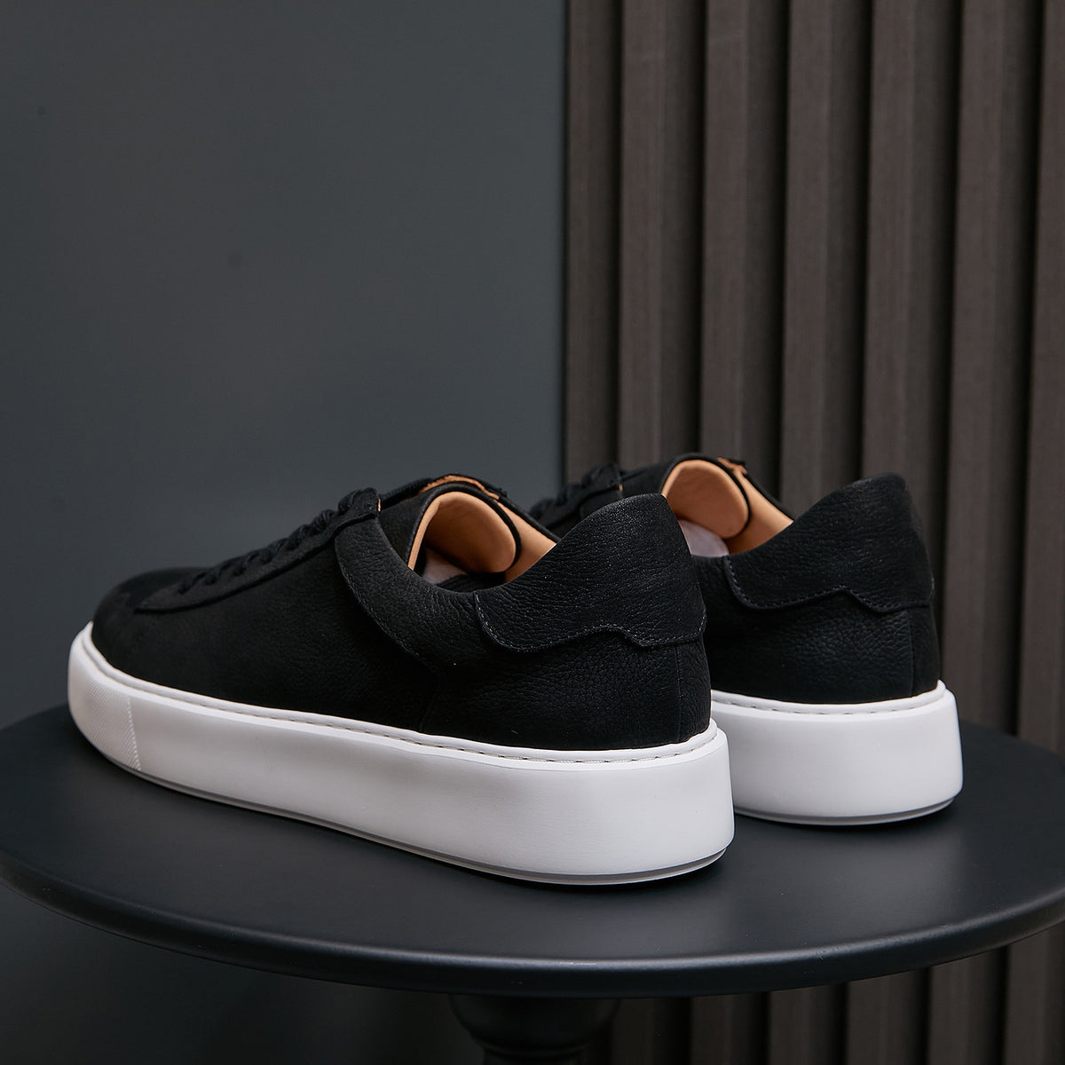 Men's genuine leather sneakers, black, rear view with padded heel and white midsole