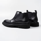 Black leather slip-on Chelsea dress boots with elastic gore and chunky sole