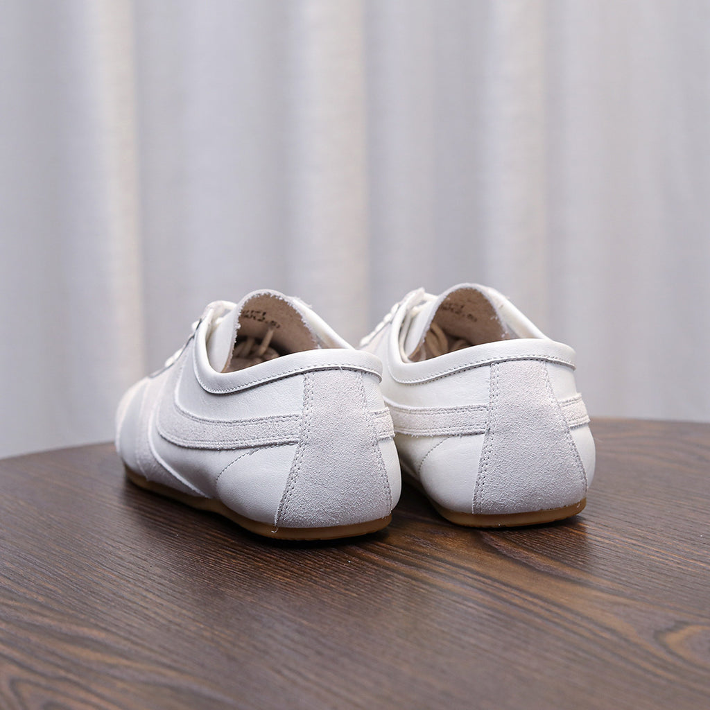 Men's white leather sneakers, rear view with lace-up closure and cushioned heel