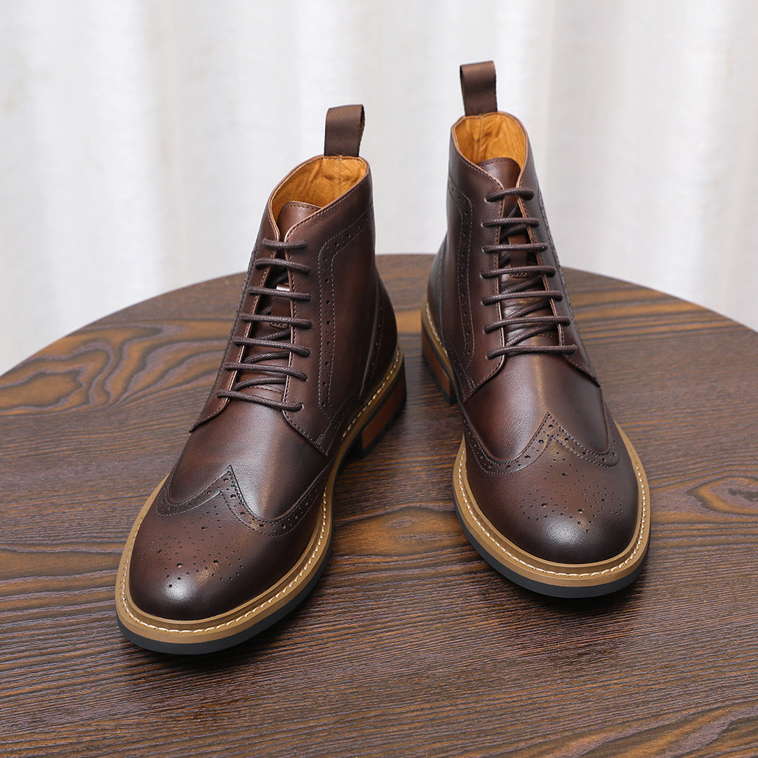 Pair of dark brown leather lace-up chukka boots with wingtip accents and tan soles