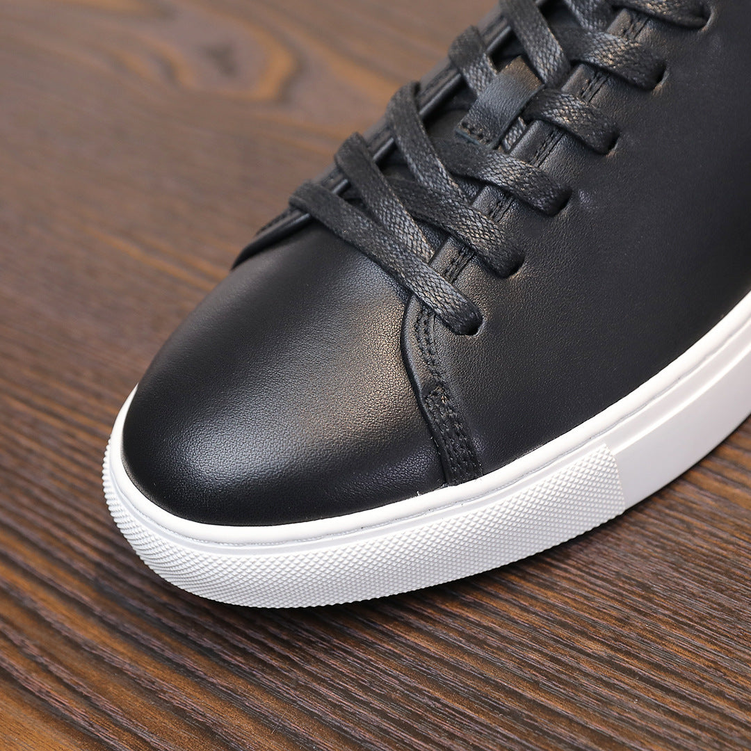 Black leather lace-up sneaker close-up with white platform sole edge.