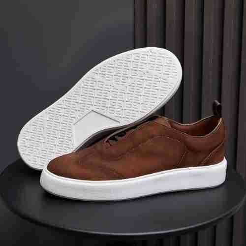 Brown leather sneakers with white outsole tread and low-profile white midsole