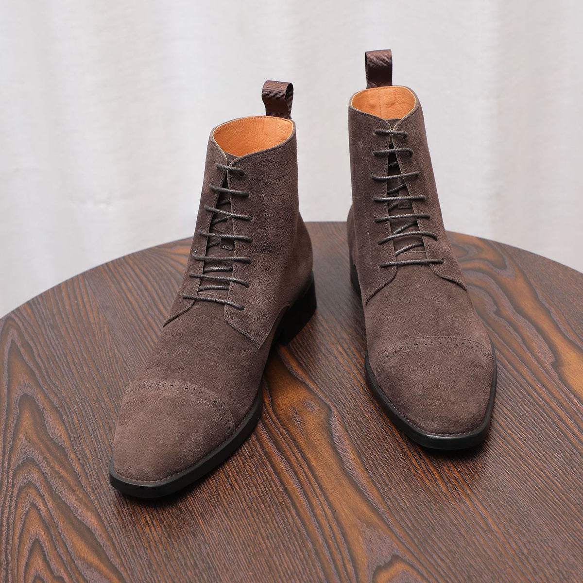 Dark brown suede lace-up chukka boots with plain toe and padded collar
