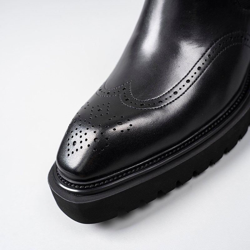 Black leather dress boot toe with perforated brogue detailing and stitched edge