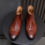 Pair of brown Chelsea dress boots, pointed toe, elastic gussets, and tan lining