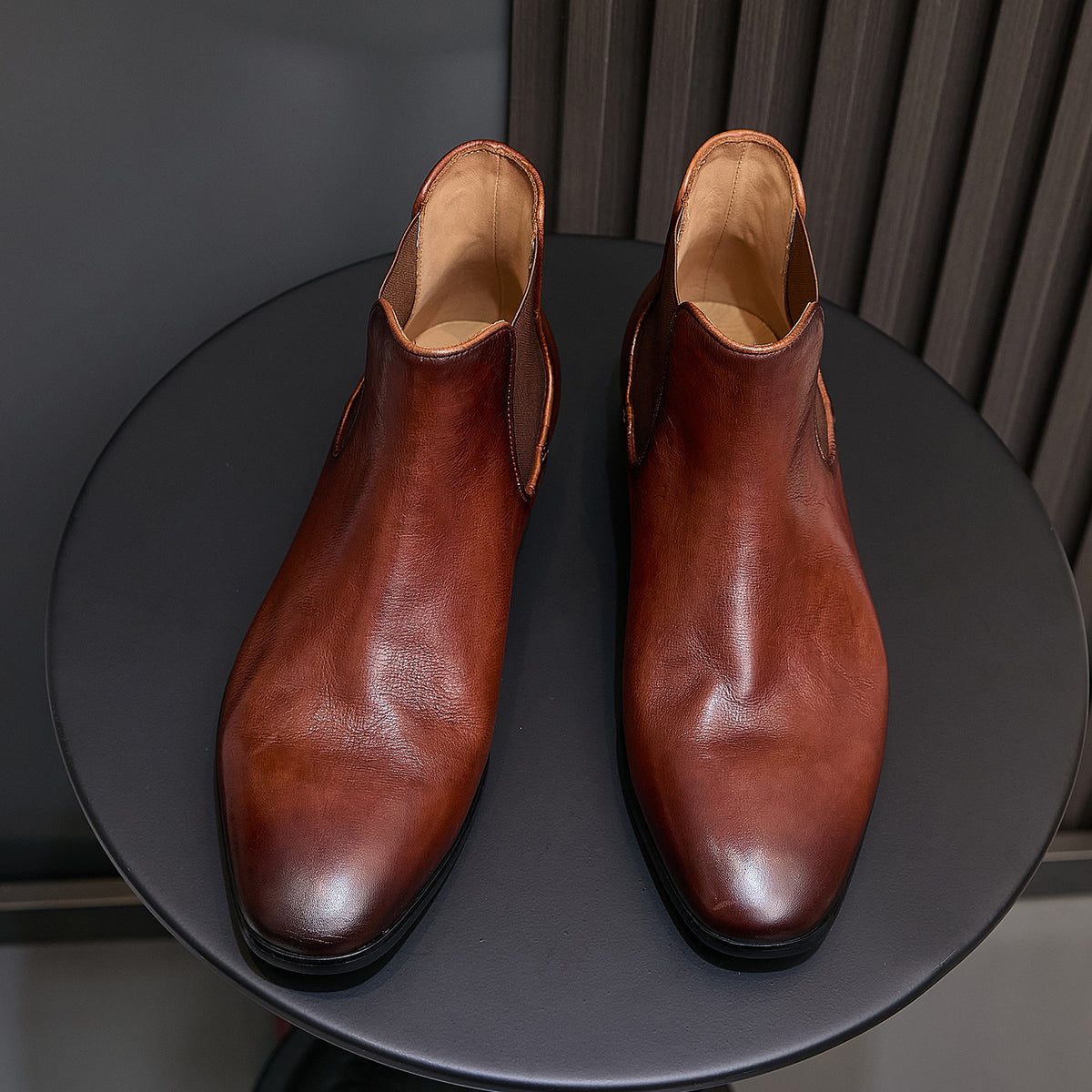 Pair of brown Chelsea dress boots, pointed toe, elastic gussets, and tan lining