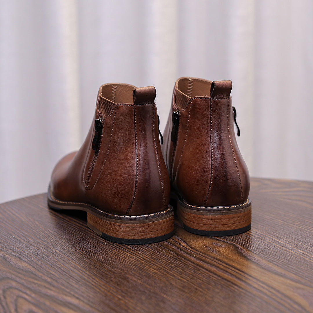 Brown leather pointed-toe ankle dress boots with side zippers, back view.