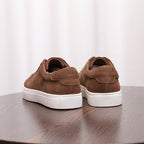 Pair of brown suede leather sneakers with lace-up vamps and white cupsoles