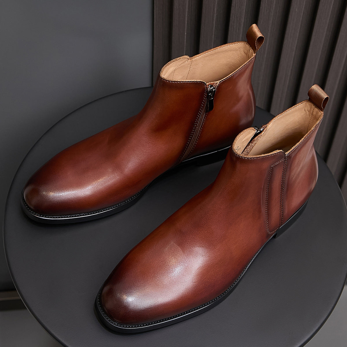 Men's pointed-toe leather dress boots with side zip, dark brown leather on display.