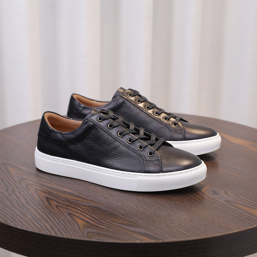 Black genuine leather low-top sneakers with lace-up front and white rubber sole