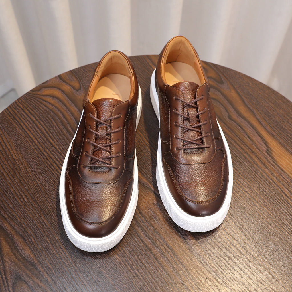 Dark brown leather lace-up sneakers front view with white sole and tan interior lining