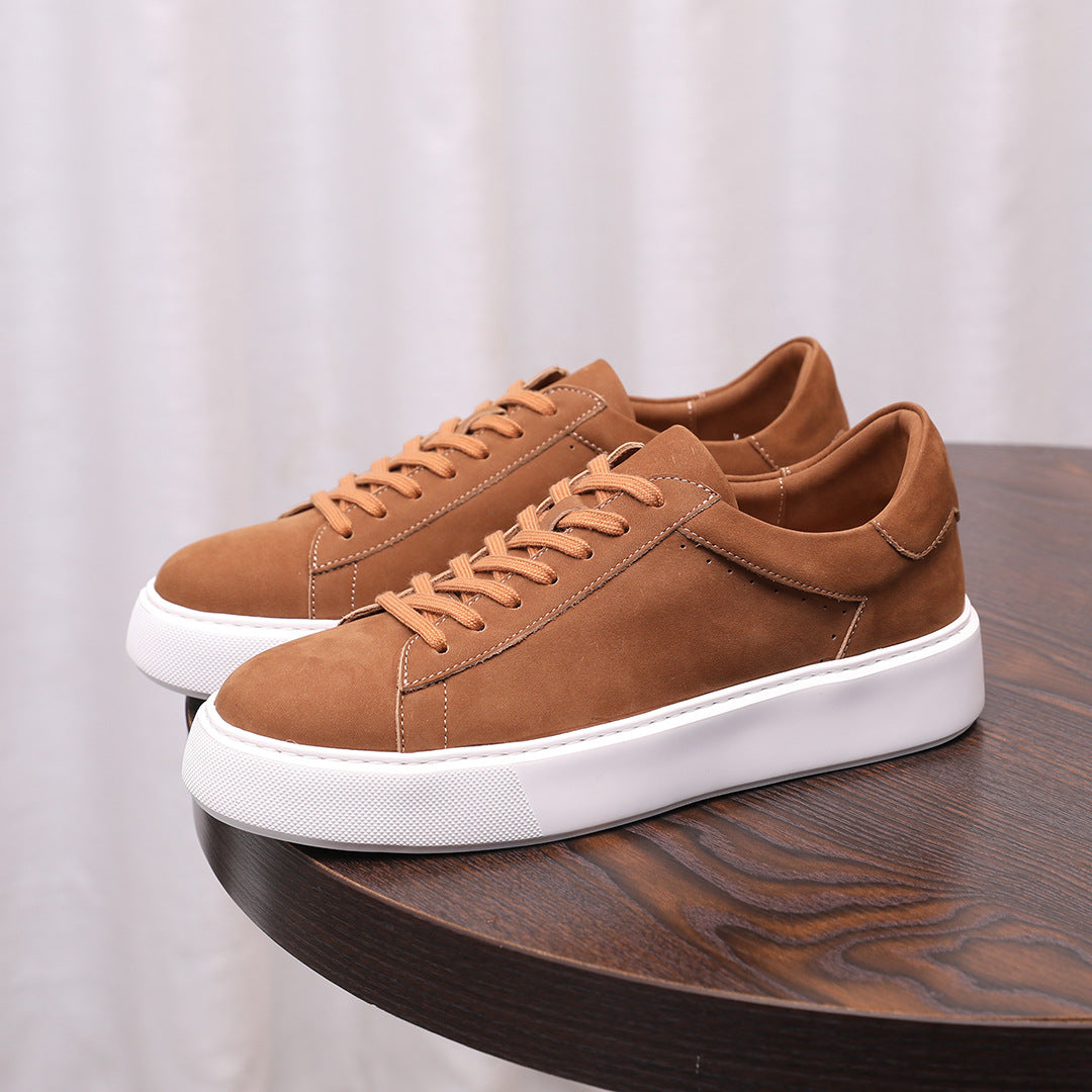 Pair of men's brown suede leather sneakers with lace-up front and white sole