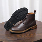Dark brown leather chukka boots with lace-up closure and visible black outsole tread