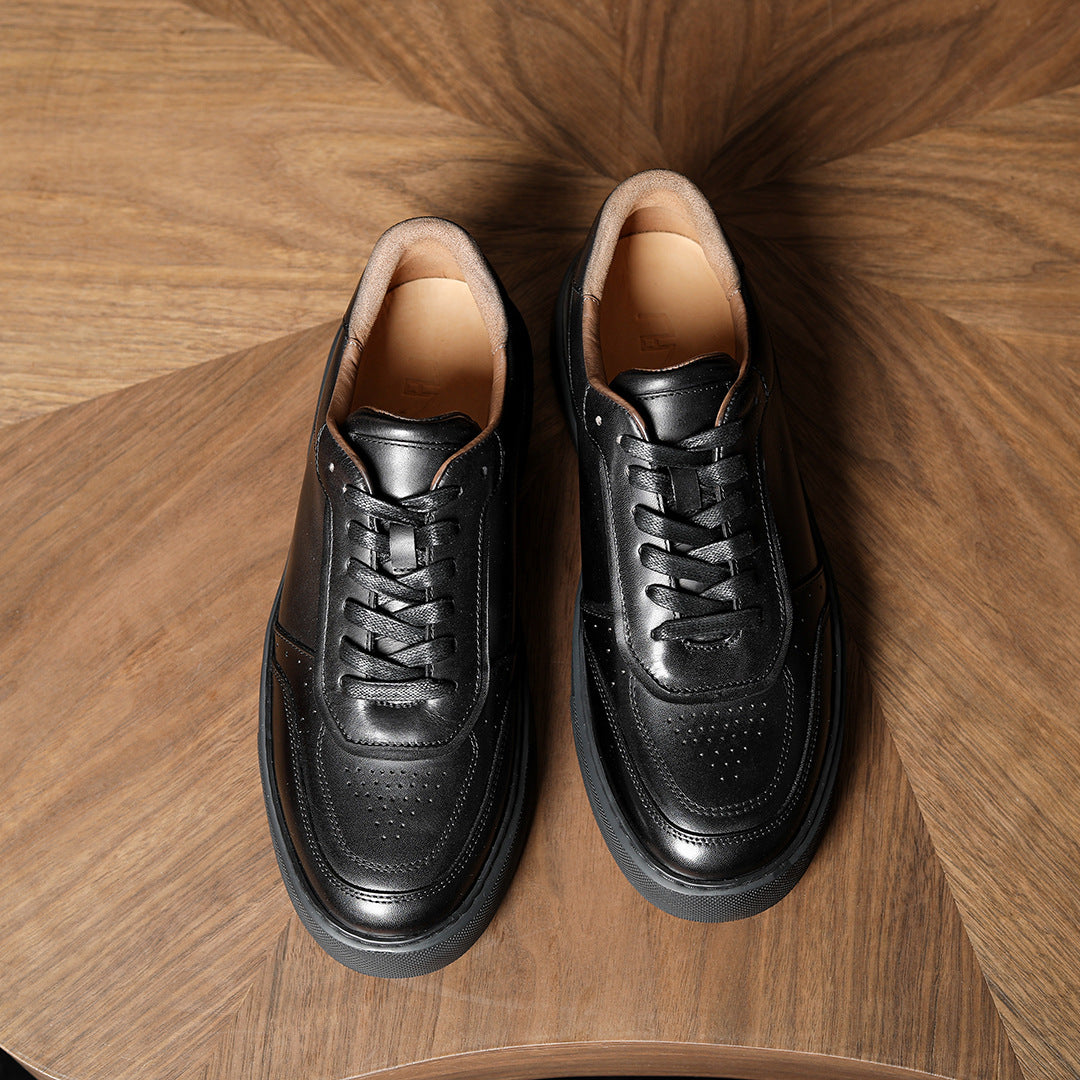 Black genuine leather sneakers, top view with lace-up front and perforated toe panels