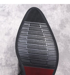 Black boot outsole with textured tread and red accent strip