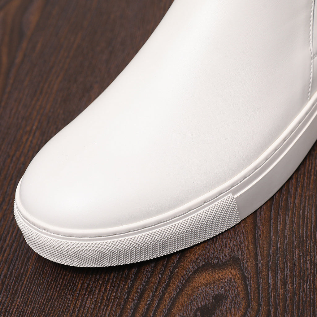 White leather pointed-toe boot with textured rubber outsole and side seam details
