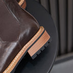 Men's pointed-toe suede Chelsea dress boots, dark brown, side close-up on sole and stitching