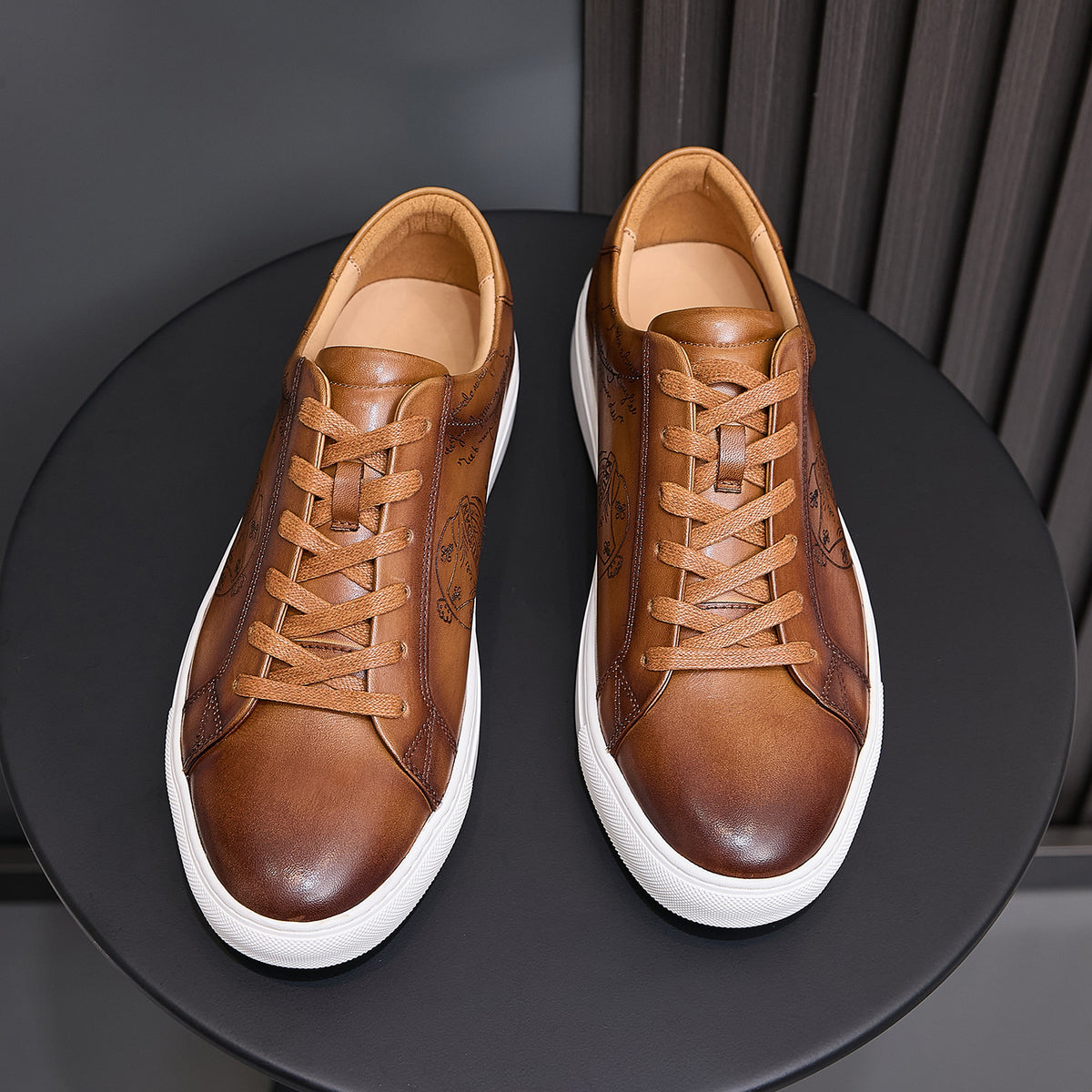 Men's tan leather lace-up sneakers with embossed texture and white rubber sole