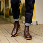Men's pointed-toe dark brown leather ankle boots with lace-up closure and welt stitching