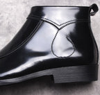 Black leather boot upper close-up with stitched detail and thick sole
