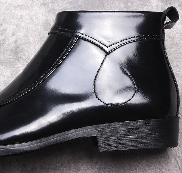 Black leather boot upper close-up with stitched detail and thick sole