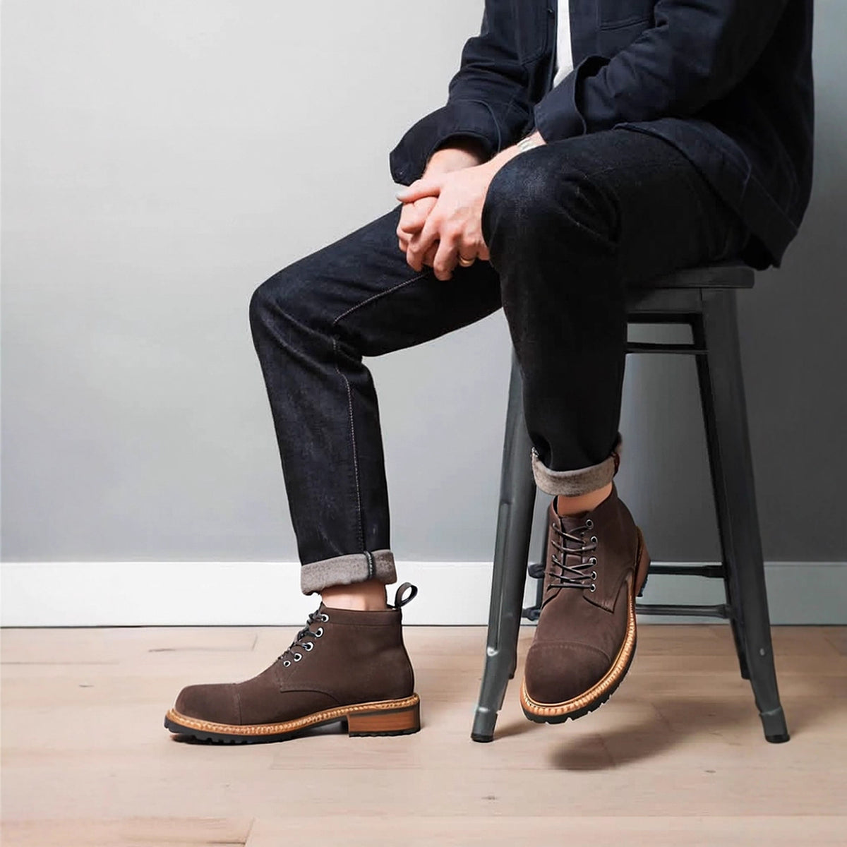 Dark brown leather chukka boots with plain toe and lace-up closure