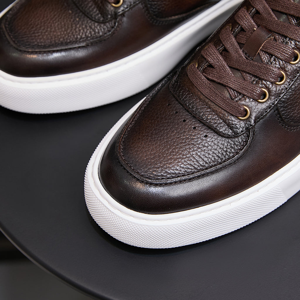 Men's dark brown leather sneaker toe and laces with textured panel and white sole edge