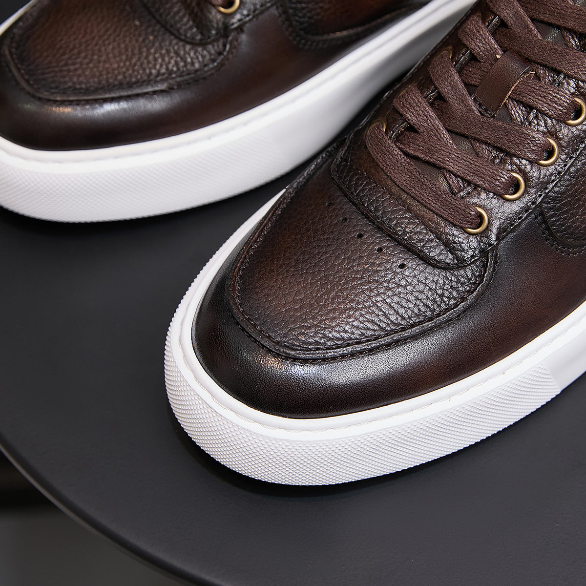 Men's dark brown leather sneaker toe and laces with textured panel and white sole edge
