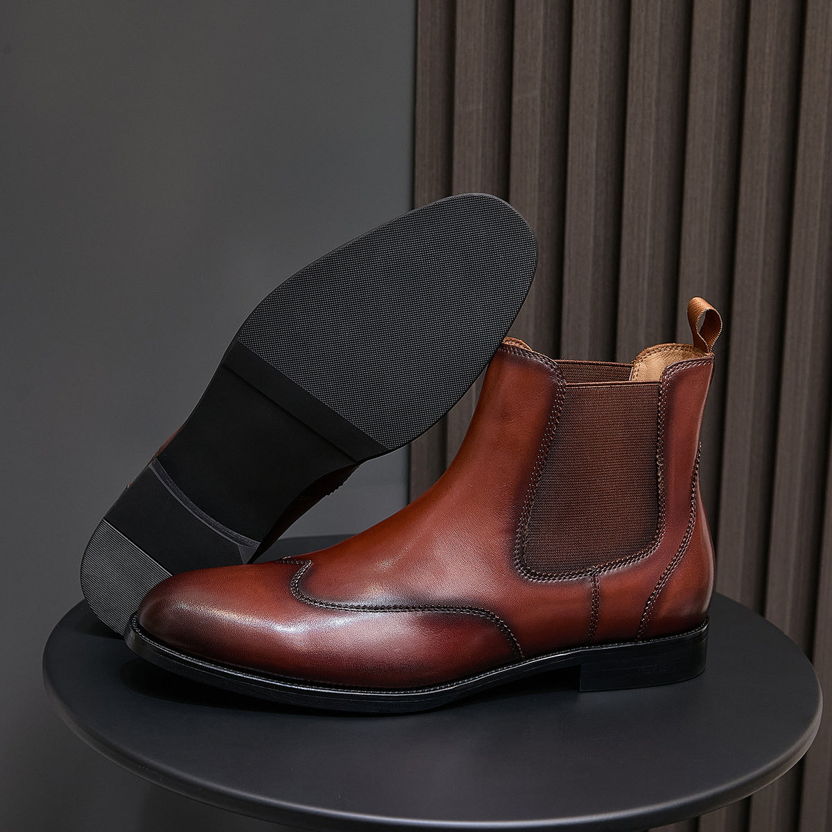 Men's pointed-toe Chelsea dress boots in dark brown, showing heel and outsole