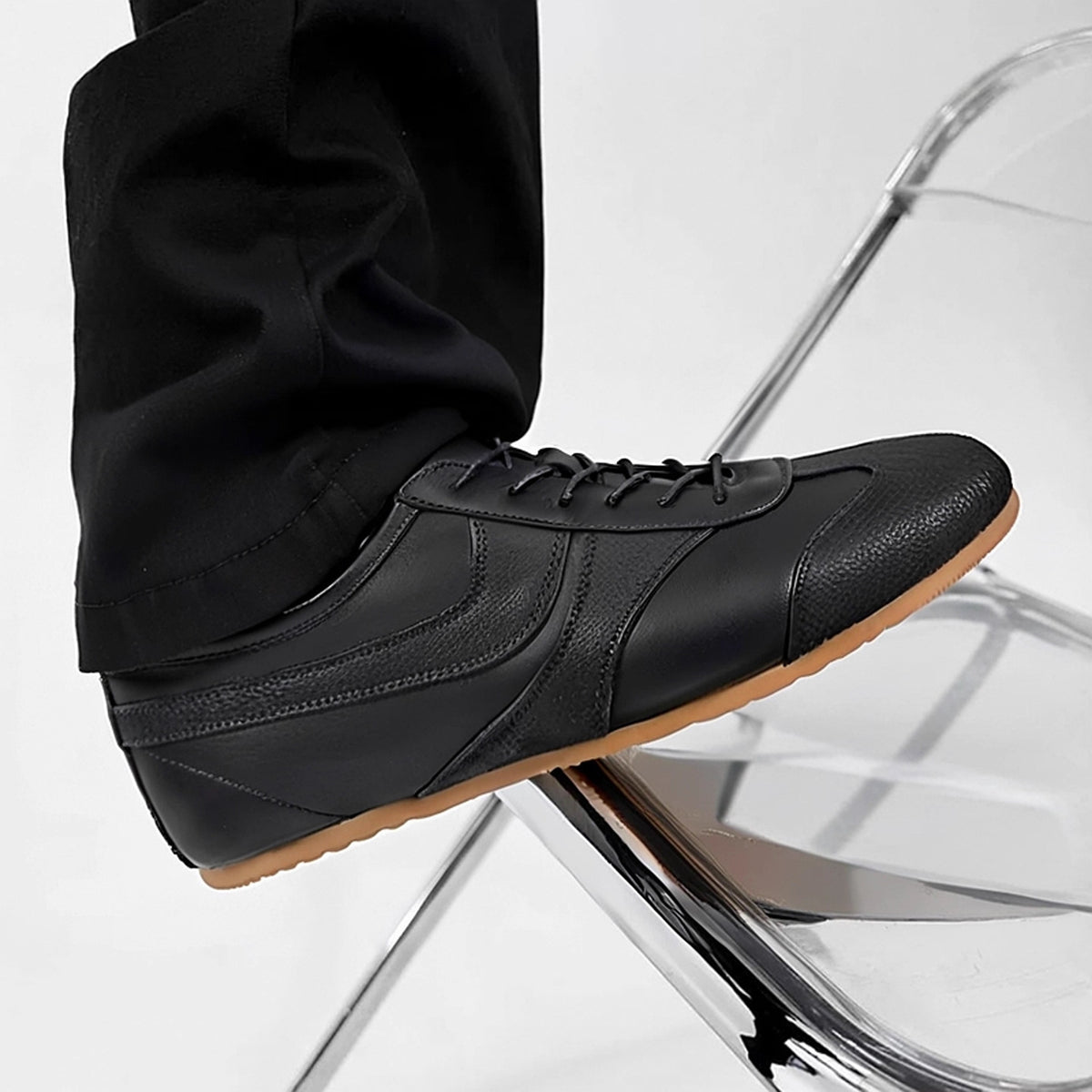 Men's black leather sneakers with lace-up design and gum rubber sole