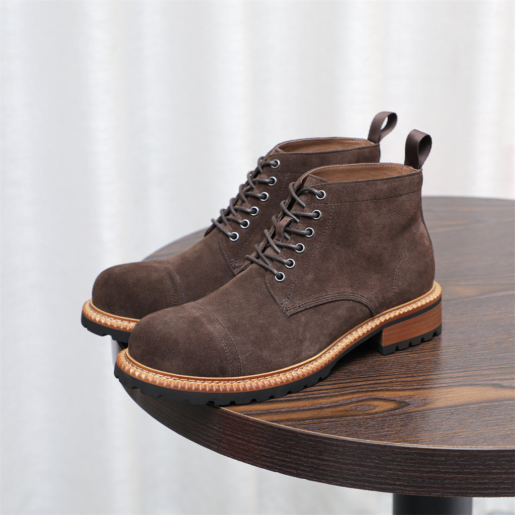 Dark brown chukka boots with lace-up front, plain toe, and rubber outsole
