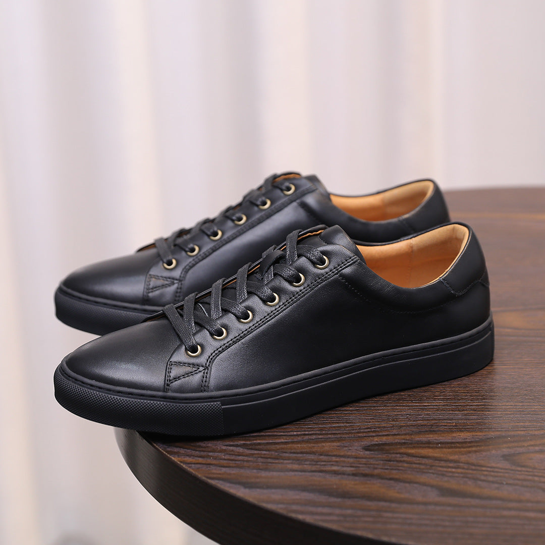 Men's genuine leather sneakers, black lace-up low-tops on a wooden surface.