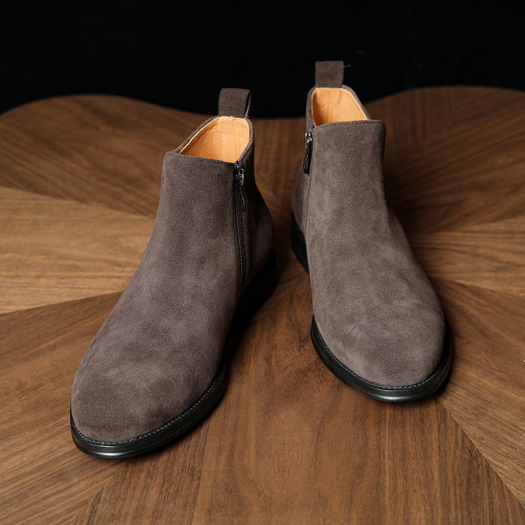 Pair of men's dark gray suede ankle dress boots with side zipper and pointed toe