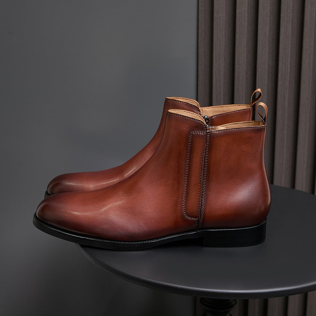 Men's pointed-toe leather dress boot with side zip, brown leather and black outsole.