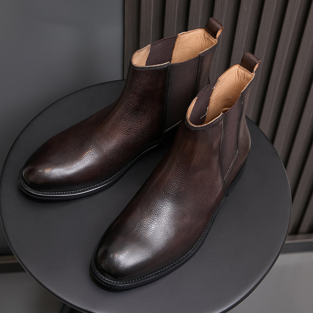 Pointed-toe Chelsea boots, dark brown, angled pair view with pull tabs and lining