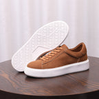 Men's brown suede leather sneakers with textured white outsole and lace-up closure