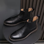 Black Chelsea dress boots angled view with elastic gore and low profile sole