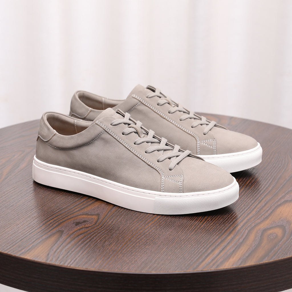 Gray suede leather sneakers with lace-up front and white rubber sole