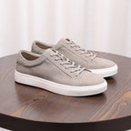 Gray suede leather sneakers with lace-up front and white rubber sole