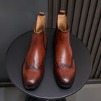 Men's pointed-toe Chelsea dress boots in dark brown, pair view with elastic side goring
