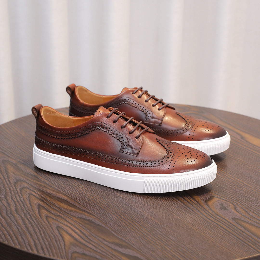 Brown leather lace-up sneakers with wingtip perforations and white midsole